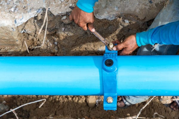 A photo of a plumber tightening a pipe