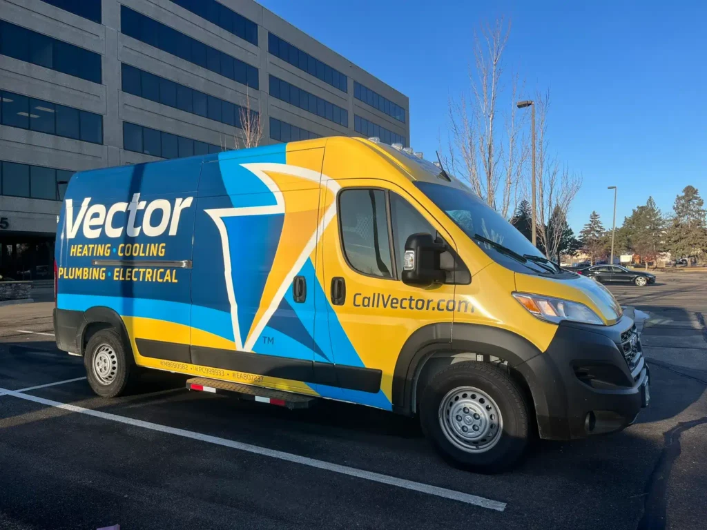 Vector Services heating, cooling, plumbing, and electrical service van parked outside the company's office, showcasing the trusted local home service brand.