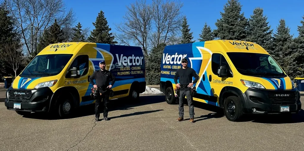 two team members stand in front of two service vans from Vector Services, ready to provide HVAC, plumbing, and electrical services to homeowners in Plymouth, MN