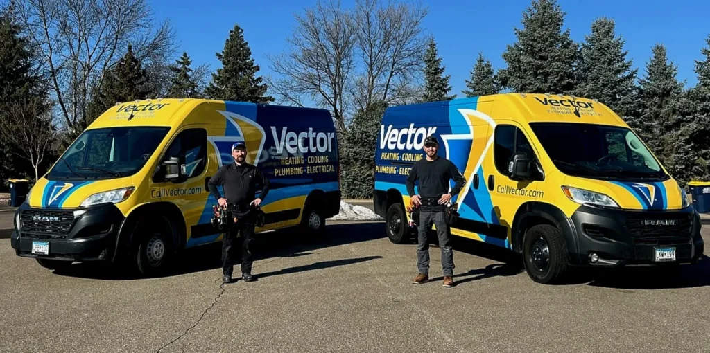 two team members stand in front of two service vans from Vector Services, ready to provide HVAC, plumbing, and electrical services to homeowners in Minnetonka, MN